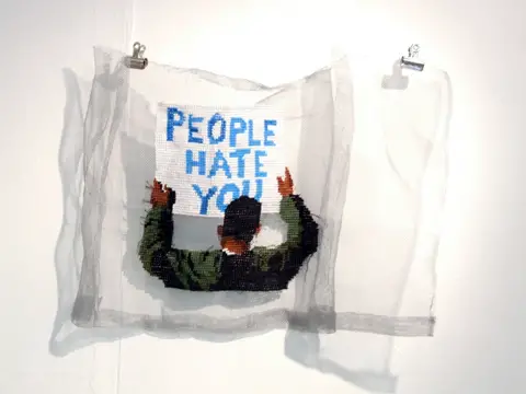 Ami Grinsted - people hate you hand embroidery on metal