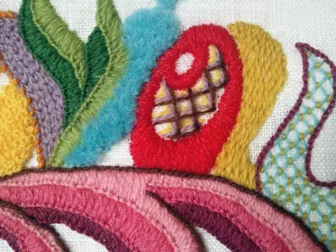 A sampler of a variety of filling stitches: in purple is chain stitch; green and pink, blankets stitch; blue, turkey knots; red, satin stitch; brown etc,  lattice; mustard, burden stitch ; light blue, couched lattice.