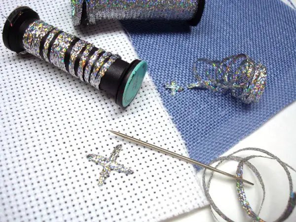 Kreinik has two sizes of metallic ribbons for stitching. Use your needle or finger to keep the ribbon flat as you place your stitch.