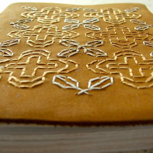Blackwork embroidery on leather journal by Smallest Forest
