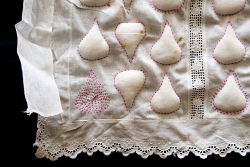 Image showing detail of art apron by Ruth Singer using trapunto and embroidery