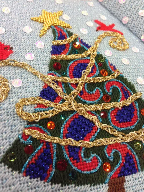 A variety of threads, sequins, beads and stitches bring this painted needlepoint canvas to life.