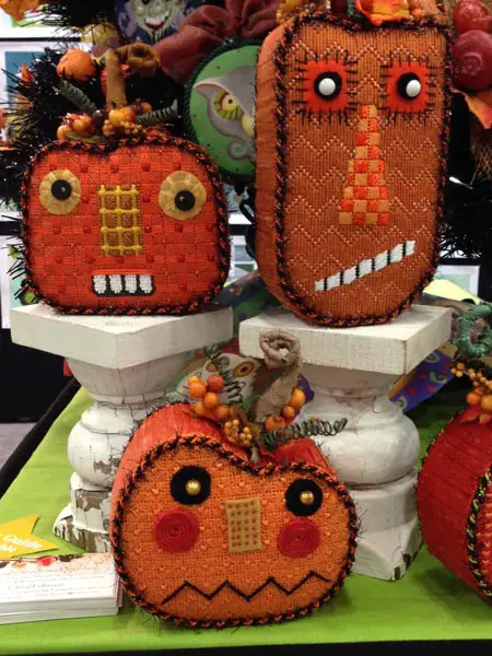 Needlepoint pumpkins get personality and pizazz through fabric and fibers, beads and buttons.