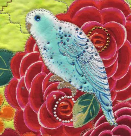 Beaded and embroidered bird by Cathie Hoover, using Kreinik metallic threads in the wings and outlines of the bird-themed fabric.