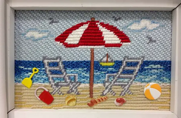 The ocean in this needlepoint canvas from Cheryl Schaeffer Designs was stitched with metallic threads to make it more realistic