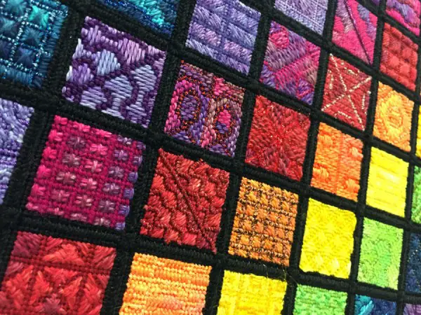 Can you spot the different types of fibers in this design? In any kind of fiber art and needlework, they are chosen to create texture and dimension. A metallic contrasting with cotton, for instance, adds variety and visual interest.