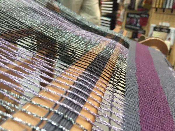 As with any fiber art, when you combine different types of yarn and thread, your finished project is more visually interesting. Use fiber, color and texture just like you would use spices and ingredients in a recipe. Kreinik Ombre is used in the warp here.