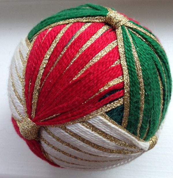 This holiday themed wrapped ball comes from the Kreinik museum. It features silk threads and Kreinik 1/8" Ribbon.
