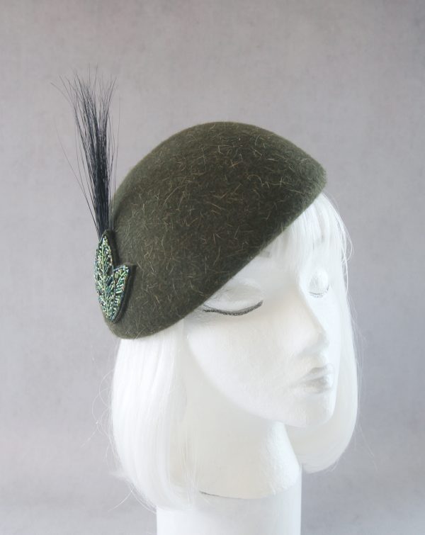 green beaded beret with feather