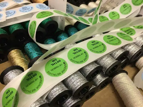 Some labels are put on the spools by hand. I'm glad they didn't ask me to do this part, I think I would be too slow (although the music in the background helps!).