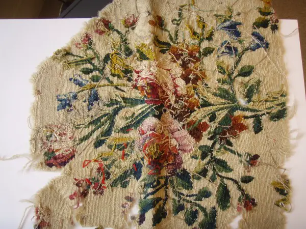 Fragment of 18th century  (?) tapestry showing reverse side. Note the warp threads and the loose threads left during weaving.  