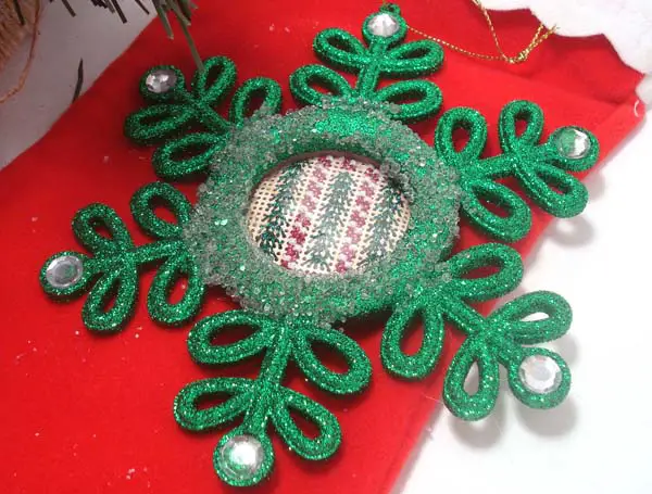 Simple stitches worked in pretty Kreinik metallic threads on perforated paper are inserted into a purchased ornament frame.