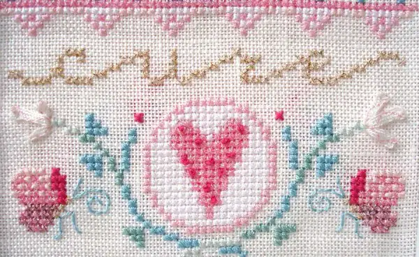 Cross stitched heart from a Breast Cancer Awareness design by Brooke Nolan for Kreinik Manufacturing Company.