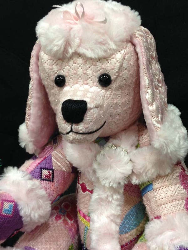 Penelope Poodle is a made by stitching various needlepoint painted canvases and having them finished as a stuffed animal (with movable legs!).