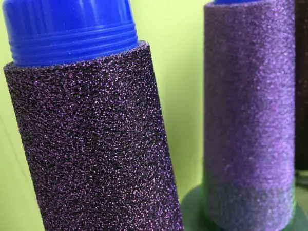 I took this photo at the Kreinik thread factory, so it shows a purple blend being made on the Kreinik machines. Don't you love this gorgeous black and purple mix? It's like night-time and outer space and fine wine mixed all together, in a fiber.
