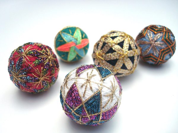 Unfortunately I don't know who made these miniature Temari balls, as they are part of the Kreinik family collection. They are only about an inch to two inches in diameter—mini marvels of Kreinik metallic threads on top of silk and sewing threads.