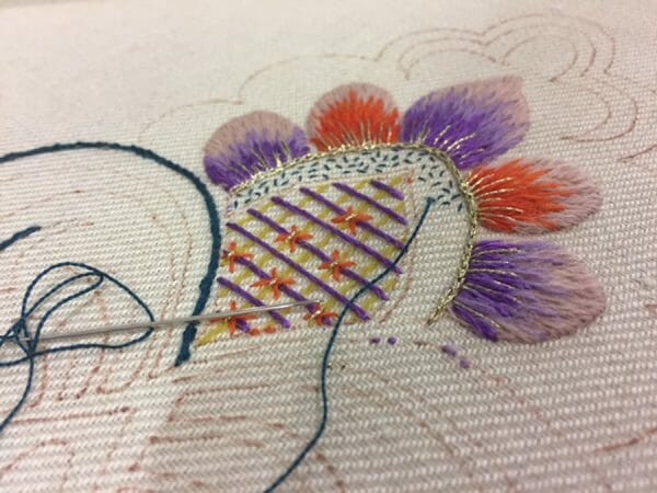 This is Lucy Barter's doodle cloth she worked on during the recent TNNA (The National Needlearts Association) trade show in San Jose California. Can you spot the Kreinik metallic thread?