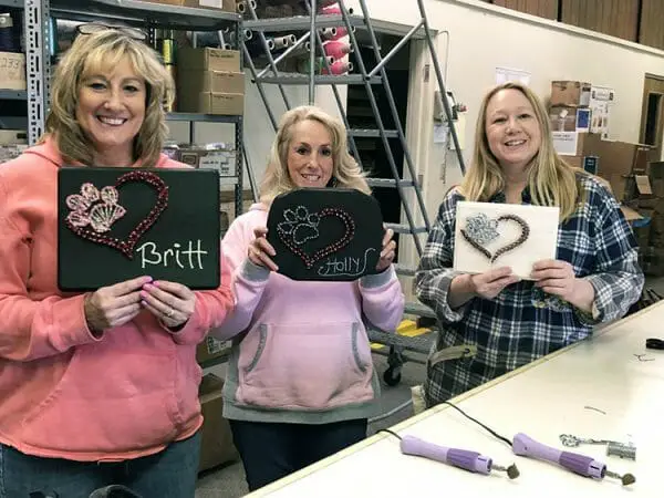 A few of the attendees at Kreinik's string art class are all smiles with their string art creations. Having fun and playing with threads can do that to a person :)