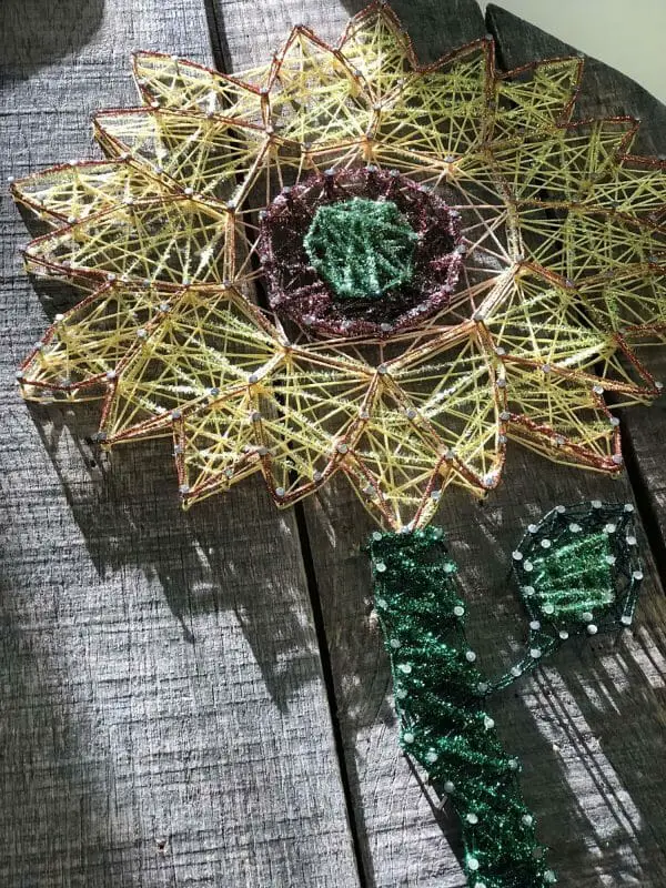 This sparkler was made by Samantha Tornes using a variety of Kreinik threads. She went wild, had fun, and found creative freedom. It's string art. 