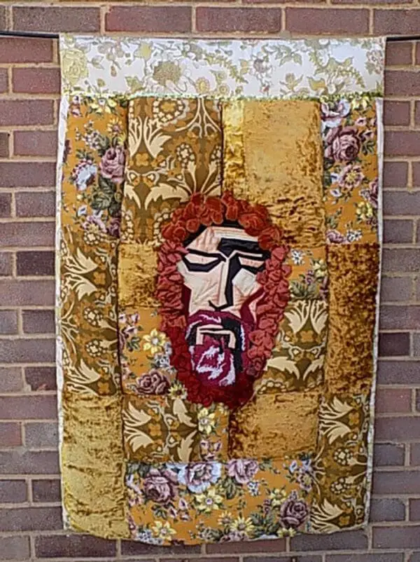 Christine Cunningham - Jesus 2 - The flat applique face of Jesus is inset by padded panels created from vintage fabrics from my childhood.