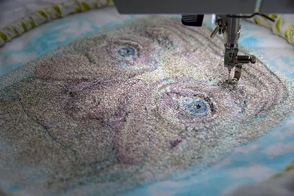 Dad's face under the sewing machine, by Julie Heaton